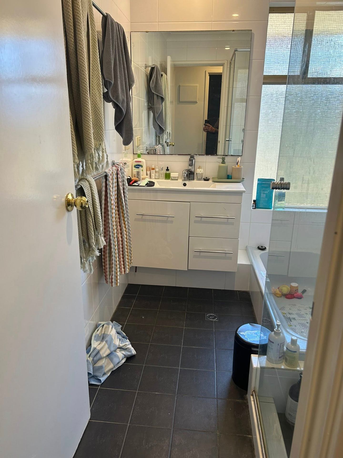 Before photo — Family bathroom in Safety Bay — vanity, mirror, floors, and bath cleared and freshened up. in Rockingham